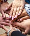 Multiple people holding hands